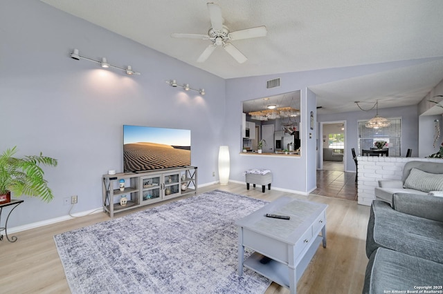3734 Colter, San Antonio, TX 78247 - living area with a ceiling fan, wood finished floors, vaulted ceiling, and baseboards