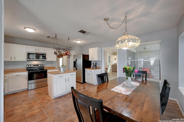 3734 Colter, San Antonio, TX 78247 - dining area with a chandelier, a textured ceiling, and light tile patterned flooring
