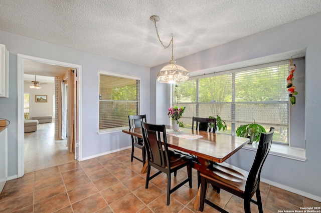 3734 Colter, San Antonio, TX 78247 - dining room with a chandelier, a textured ceiling, baseboards, and tile patterned floors