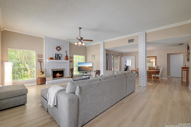 3734 Colter, San Antonio, TX 78247 - living room featuring light wood-style flooring, a textured ceiling, ornamental molding, ceiling fan, and healthy amount of natural light