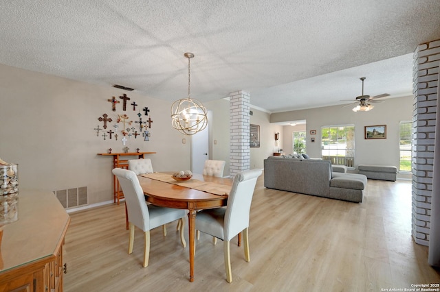 3734 Colter, San Antonio, TX 78247 - dining area with light wood-type flooring, a ceiling fan, a chandelier, a textured ceiling, and baseboards