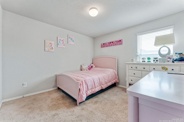 2946 Daisy Mdw, New Braunfels, TX 78130 - bedroom featuring light carpet, a textured ceiling, and baseboards