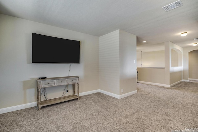 27013 Camellia Trce, Boerne, TX 78015 - unfurnished living room featuring carpet floors, baseboards, and arched walkways