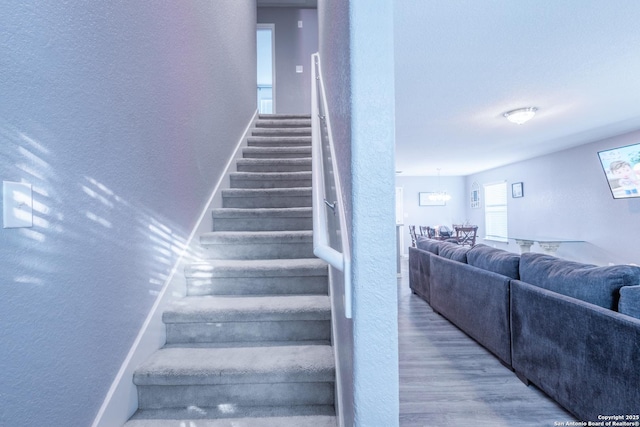 5634 Forest Cyn, San Antonio, TX 78252 - stairs with a textured wall, wood finished floors, and a chandelier