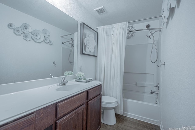 5634 Forest Cyn, San Antonio, TX 78252 - full bathroom with shower / tub combo, vanity, toilet, wood finished floors, and a textured ceiling