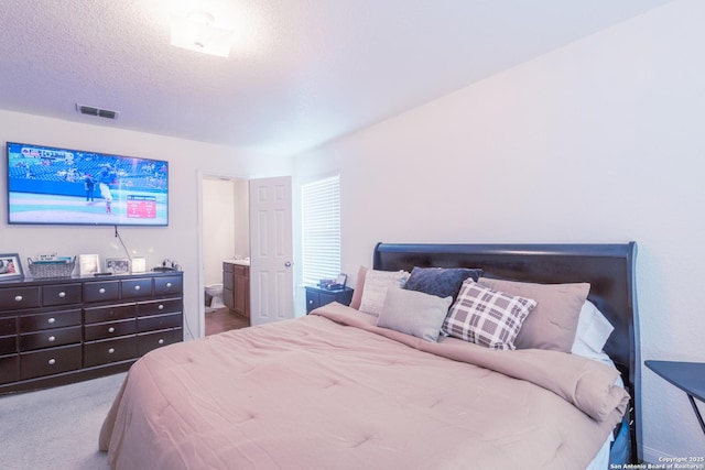 5634 Forest Cyn, San Antonio, TX 78252 - carpeted bedroom with ensuite bathroom and a textured ceiling