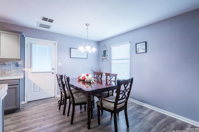 5634 Forest Cyn, San Antonio, TX 78252 - dining area with a chandelier, wood finished floors, baseboards, and a textured wall