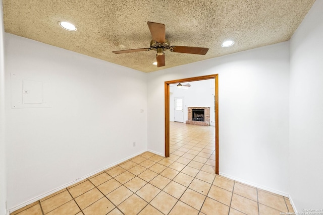 11415 Rousseau St, San Antonio, TX 78251 - empty room featuring ceiling fan, recessed lighting, a fireplace, baseboards, and light tile patterned flooring