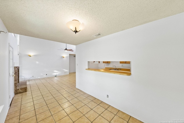 11415 Rousseau St, San Antonio, TX 78251 - unfurnished room with ceiling fan, light tile patterned floors, a textured ceiling, and a sink
