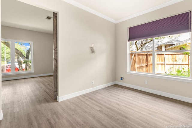 122 Kettle Cv, Universal City, TX 78148 - spare room featuring wood finished floors, ornamental molding, and baseboards