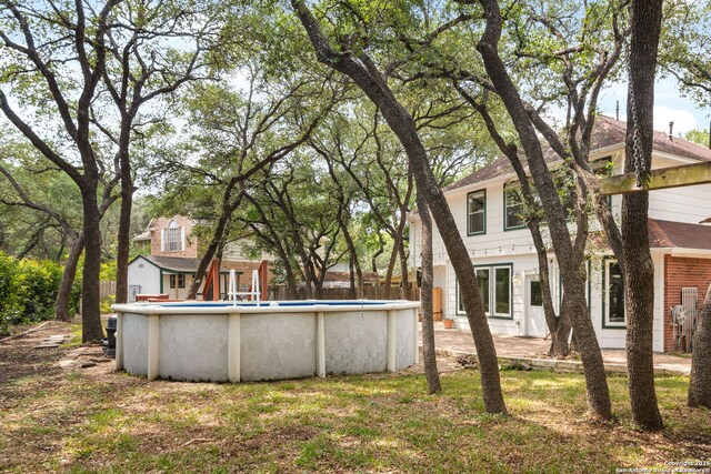 122 Kettle Cv, Universal City, TX 78148 - back of house with roof with shingles