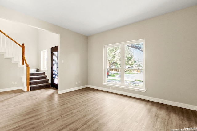 122 Kettle Cv, Universal City, TX 78148 - spare room with wood finished floors, stairway, and baseboards