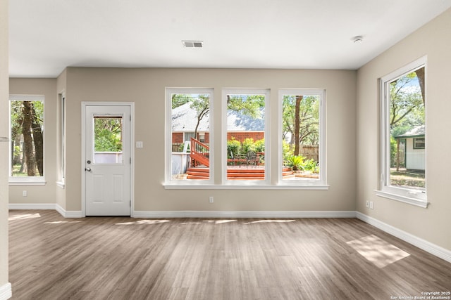 122 Kettle Cv, Universal City, TX 78148 - unfurnished living room with wood finished floors and baseboards