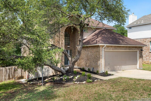 959 Lightstone Dr, San Antonio, TX 78258 - traditional-style home with brick siding, an attached garage, roof with shingles, and driveway