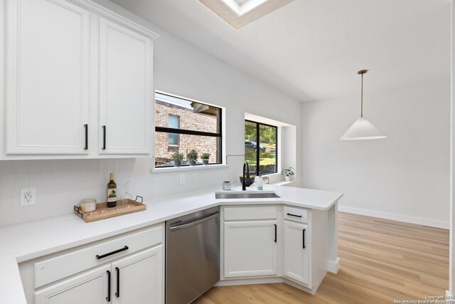 959 Lightstone Dr, San Antonio, TX 78258 - kitchen with dishwasher, a sink, a peninsula, light wood finished floors, and white cabinetry