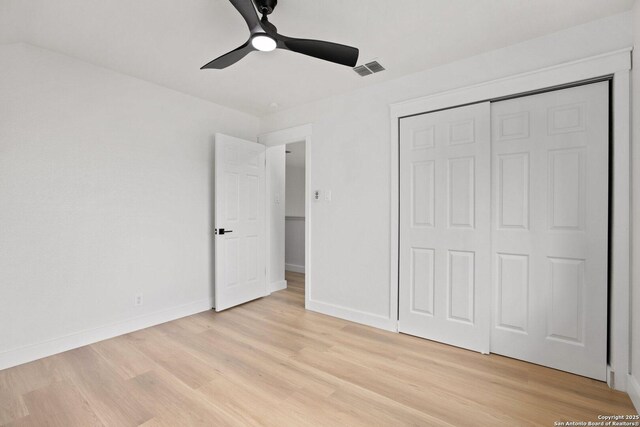 959 Lightstone Dr, San Antonio, TX 78258 - unfurnished bedroom featuring light wood-type flooring, baseboards, a closet, and a ceiling fan
