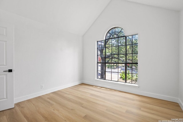 959 Lightstone Dr, San Antonio, TX 78258 - empty room featuring healthy amount of natural light, wood finished floors, baseboards, and high vaulted ceiling