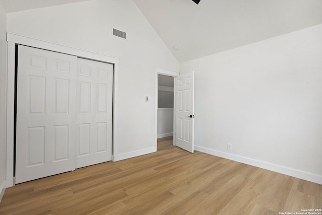 959 Lightstone Dr, San Antonio, TX 78258 - unfurnished bedroom with light wood finished floors, baseboards, high vaulted ceiling, and a closet