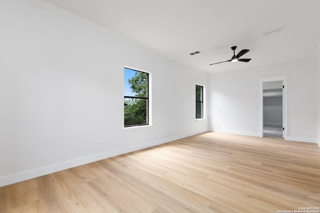 959 Lightstone Dr, San Antonio, TX 78258 - empty room featuring crown molding, light wood-type flooring, baseboards, and a ceiling fan