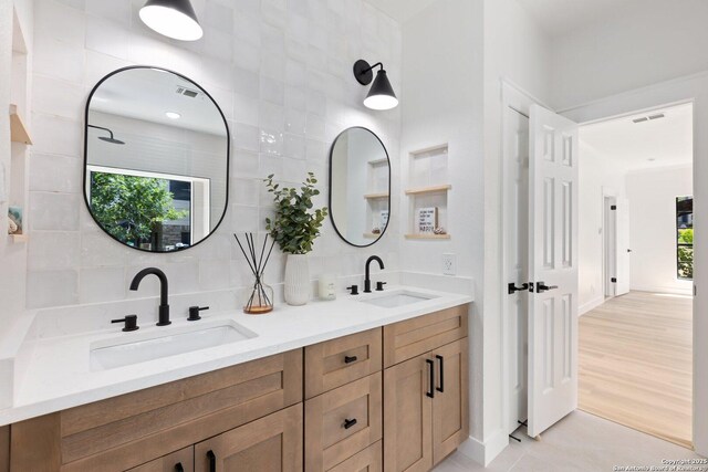 959 Lightstone Dr, San Antonio, TX 78258 - full bathroom with double vanity, healthy amount of natural light, and backsplash
