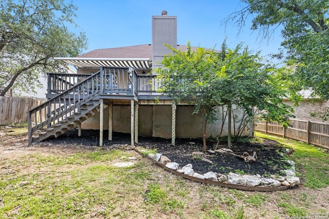 959 Lightstone Dr, San Antonio, TX 78258 - back of house featuring stairs, a deck, a chimney, and roof with shingles