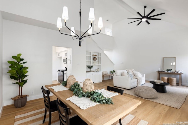 959 Lightstone Dr, San Antonio, TX 78258 - dining space featuring high vaulted ceiling, a chandelier, light wood-style flooring, and baseboards