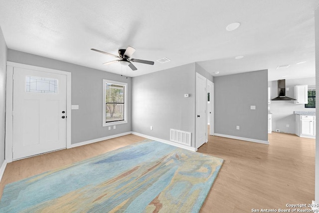 139 Wichita Ct, San Antonio, TX 78225 - entrance foyer with light wood-style flooring, a ceiling fan, baseboards, and healthy amount of natural light