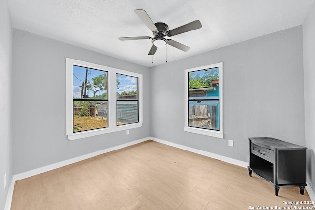 139 Wichita Ct, San Antonio, TX 78225 - unfurnished room featuring plenty of natural light, light wood finished floors, baseboards, and ceiling fan