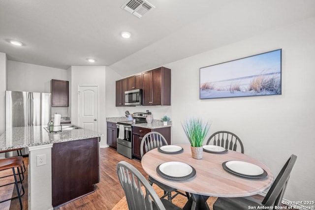 712 Monarch, Seguin, TX 78155 - dining room featuring wood finished floors, recessed lighting, and lofted ceiling