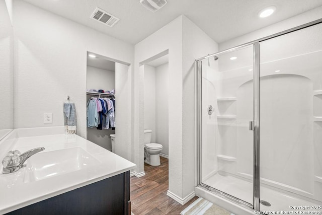 712 Monarch, Seguin, TX 78155 - bathroom with toilet, a shower stall, wood finished floors, vanity, and recessed lighting