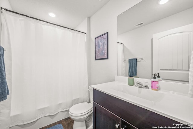 712 Monarch, Seguin, TX 78155 - full bathroom with vanity, toilet, shower / bath combination with curtain, recessed lighting, and wood finished floors