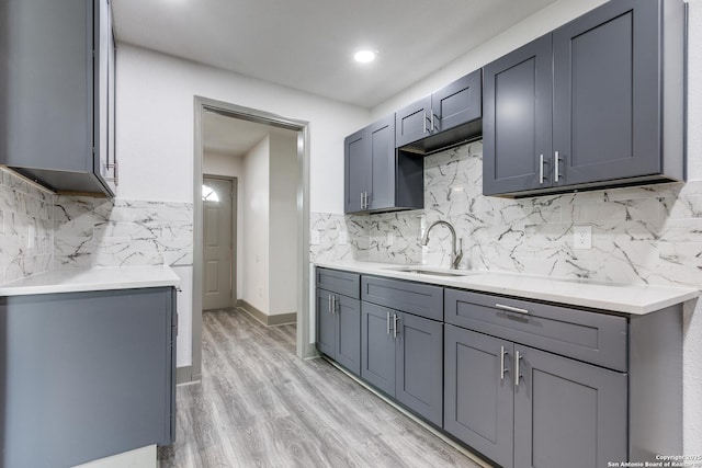 2822 Spokane, San Antonio, TX 78222 - kitchen featuring a sink, decorative backsplash, light countertops, gray cabinetry, and recessed lighting