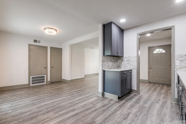 2822 Spokane, San Antonio, TX 78222 - kitchen featuring light countertops, light wood-style floors, backsplash, gray cabinets, and recessed lighting
