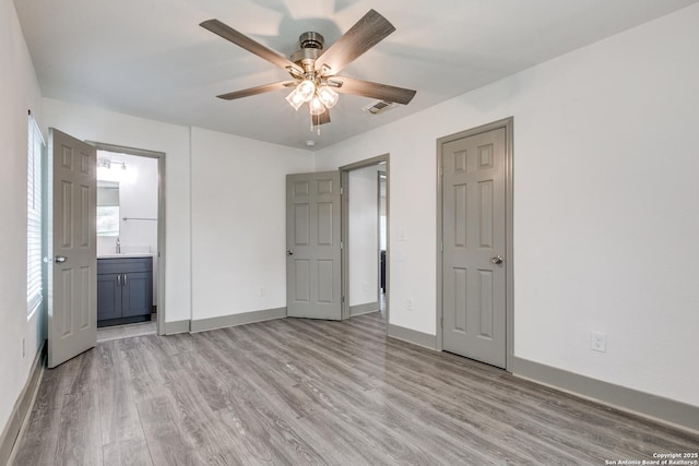 2822 Spokane, San Antonio, TX 78222 - unfurnished bedroom featuring light wood-style floors, baseboards, and ensuite bathroom