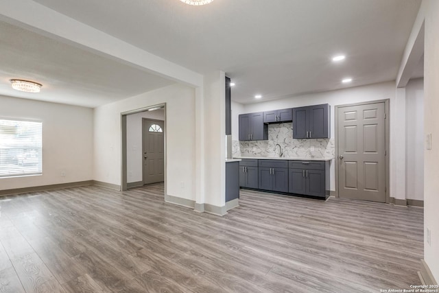 2822 Spokane, San Antonio, TX 78222 - kitchen with decorative backsplash, light wood finished floors, baseboards, light countertops, and recessed lighting