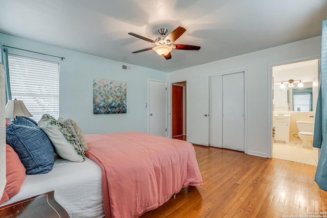 438 Cosgrove, San Antonio, TX 78210 - bedroom with light wood-style floors, multiple windows, a closet, and ceiling fan