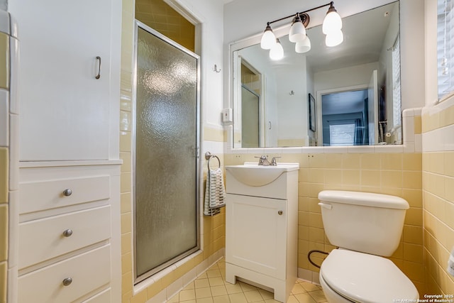 438 Cosgrove, San Antonio, TX 78210 - full bathroom with tile walls, tile patterned flooring, a stall shower, vanity, and toilet
