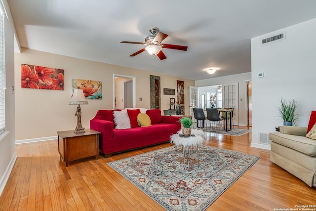 438 Cosgrove, San Antonio, TX 78210 - living area with a ceiling fan, light wood-style flooring, and baseboards
