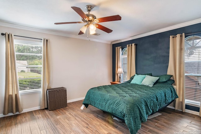 13635 Oak Breeze, Universal City, TX 78148 - bedroom featuring multiple windows, wood finished floors, ornamental molding, baseboards, and ceiling fan