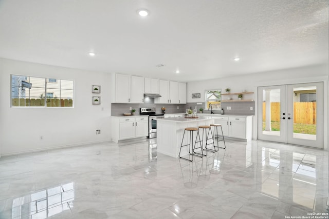 242 Butternut, San Antonio, TX 78245 - kitchen featuring electric range, plenty of natural light, light marble finish floors, and recessed lighting