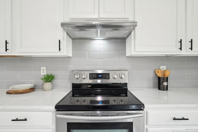 242 Butternut, San Antonio, TX 78245 - kitchen with electric stove, under cabinet range hood, white cabinets, backsplash, and light stone countertops