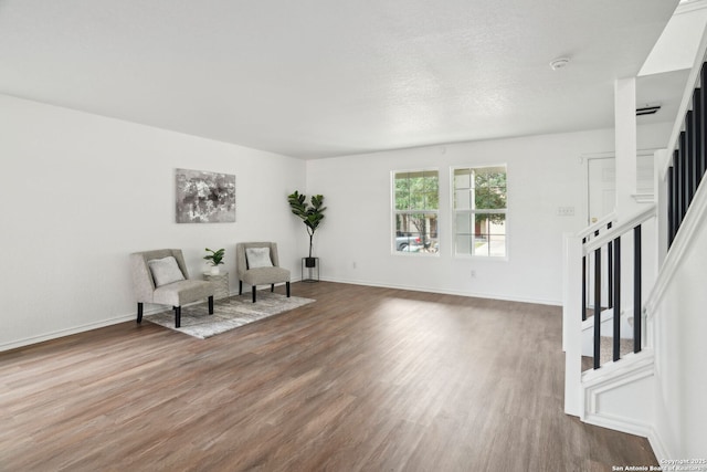 242 Butternut, San Antonio, TX 78245 - sitting room featuring stairway, wood finished floors, and baseboards