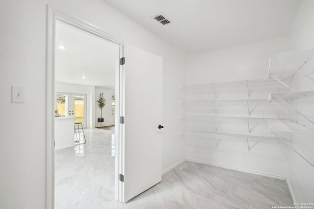 242 Butternut, San Antonio, TX 78245 - walk in closet with light marble finish floors and french doors
