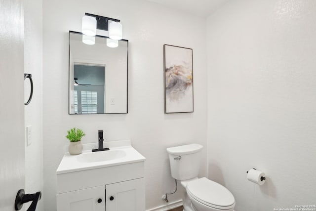 242 Butternut, San Antonio, TX 78245 - bathroom with vanity, toilet, ceiling fan, and baseboards