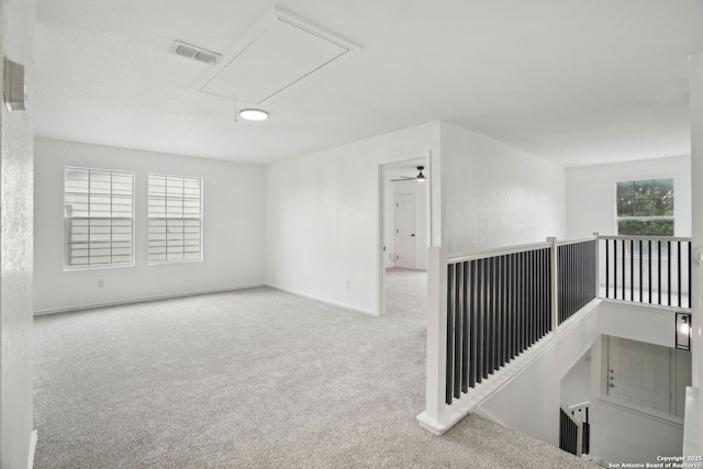 242 Butternut, San Antonio, TX 78245 - carpeted spare room with attic access, baseboards, and a ceiling fan