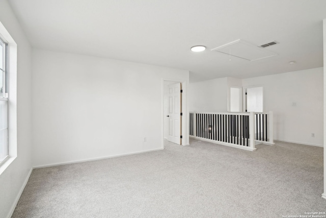 242 Butternut, San Antonio, TX 78245 - carpeted empty room with attic access, baseboards, and healthy amount of natural light