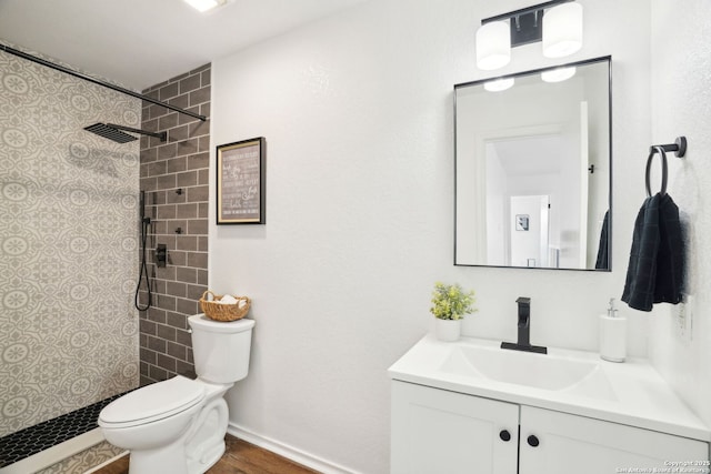 242 Butternut, San Antonio, TX 78245 - bathroom with vanity, toilet, a tile shower, and wood finished floors