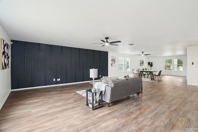 242 Butternut, San Antonio, TX 78245 - living room featuring wood finished floors, ceiling fan, and baseboards