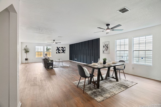 242 Butternut, San Antonio, TX 78245 - dining room featuring ceiling fan, wood finished floors, a textured ceiling, and baseboards