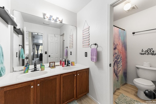 1623 Rainy Brk, Schertz, TX 78154 - full bathroom with wood finished floors, double vanity, toilet, baseboards, and a shower with shower curtain